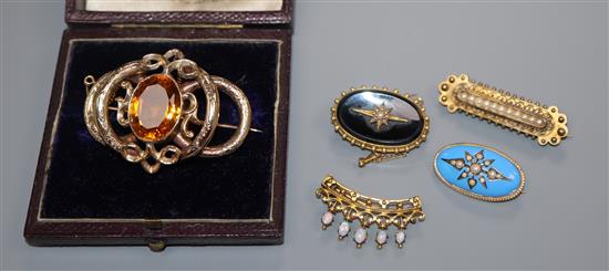 Four assorted late Victorian/Edwardian yellow metal and gem set brooches and a cased Victorian citrine set scroll brooch.